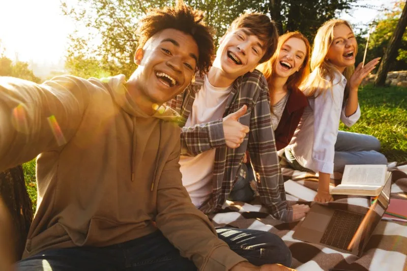 Four young people taking outdoor selfie together