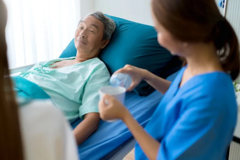 Elderly patient lying in hospital bed
