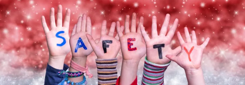 Raised children's hands with letters spelling safety