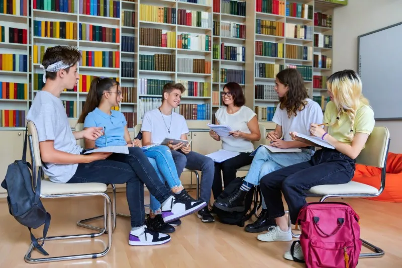 Students sitting in library discussion circle