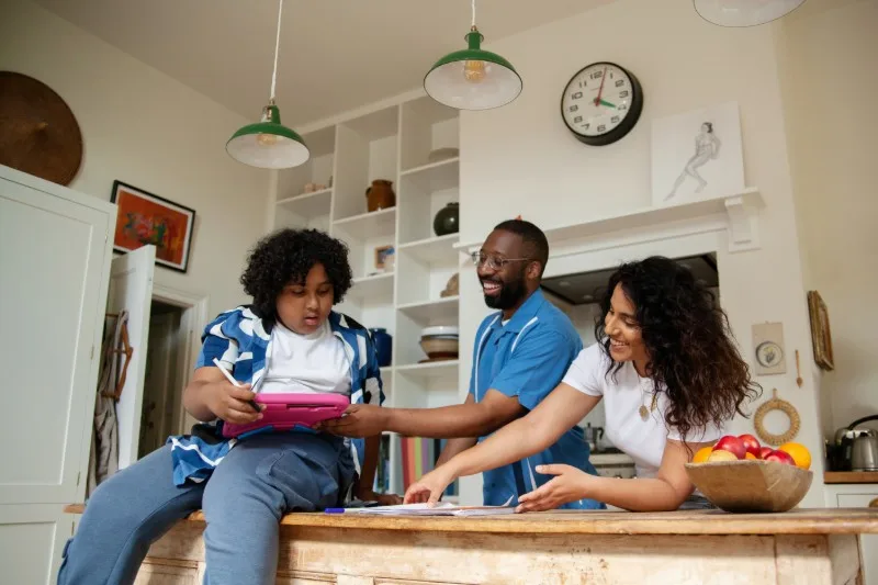 People checking food information on a tablet in a kitchen