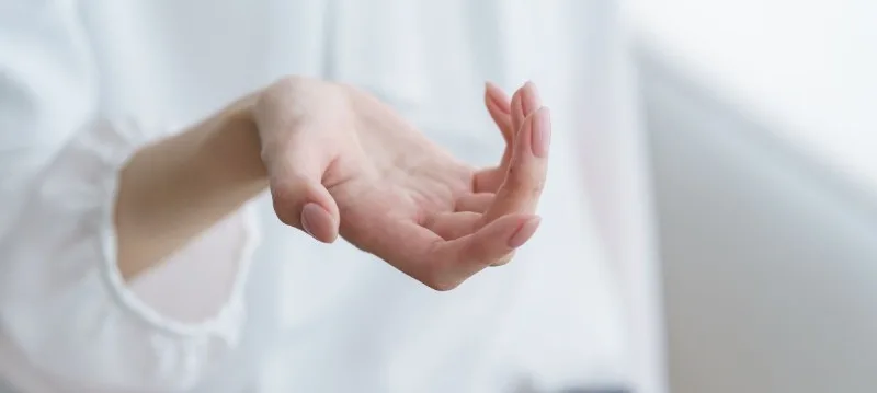 Hand held palm-up against soft background