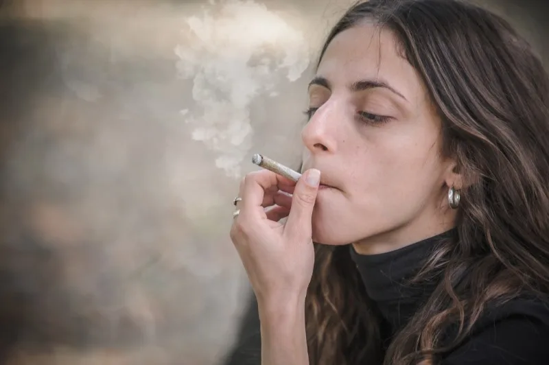 Young woman smoking a joint outdoors