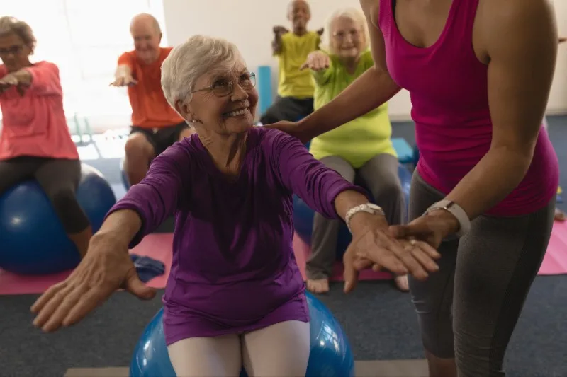 Seniors doing seated exercise on stability balls