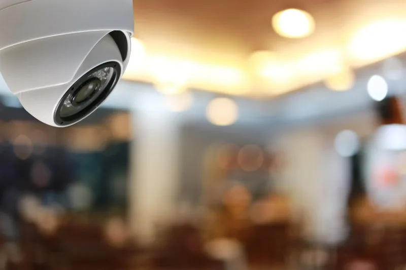 Ceiling-mounted dome surveillance camera indoors