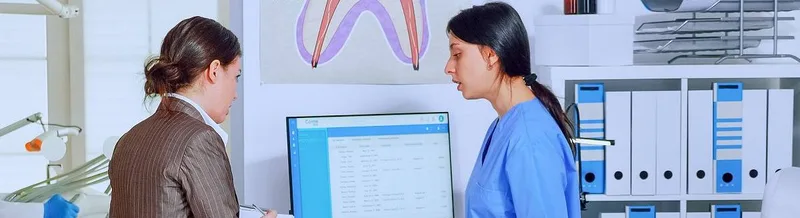 Two women reviewing patient record at computer