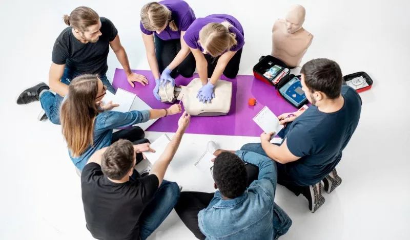 Group learning CPR on a mannequin