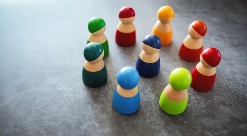 Colorful wooden peg figures arranged in a circle