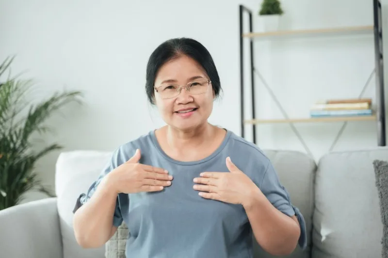 Middle-aged woman signing with both hands