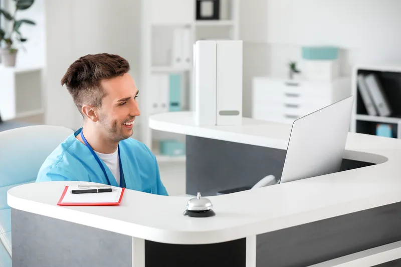 Male receptionist working in clinic