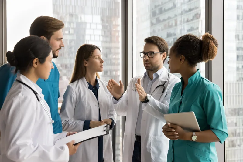 Senior clinician speaking with clinic staff