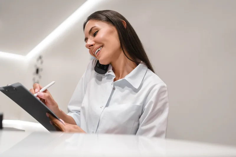 Reception specialist answering phone calls and scheduling appointments