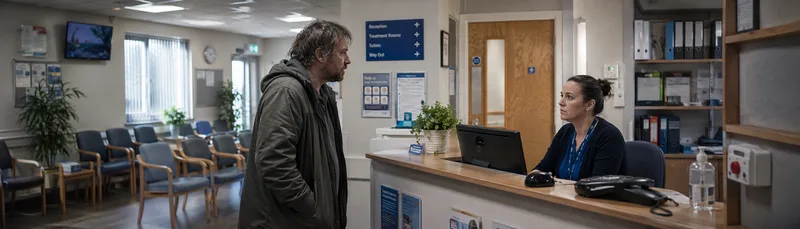 GP reception desk with receptionist and patient