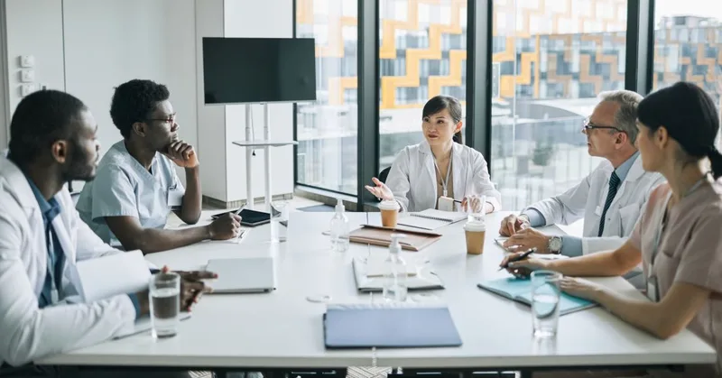 Diverse team meeting around conference table