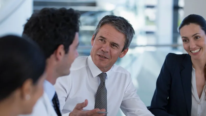 Businesspeople in a meeting around a table