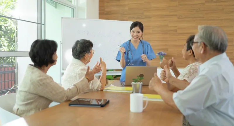Healthcare professional leading senior group meeting