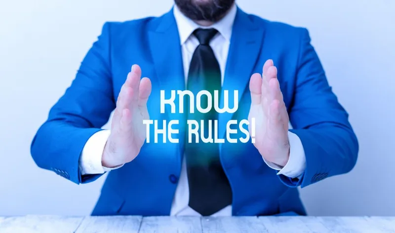 Man in blue suit gesturing around text