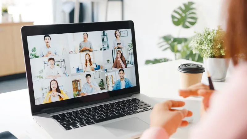 Person participating in a video conference on laptop