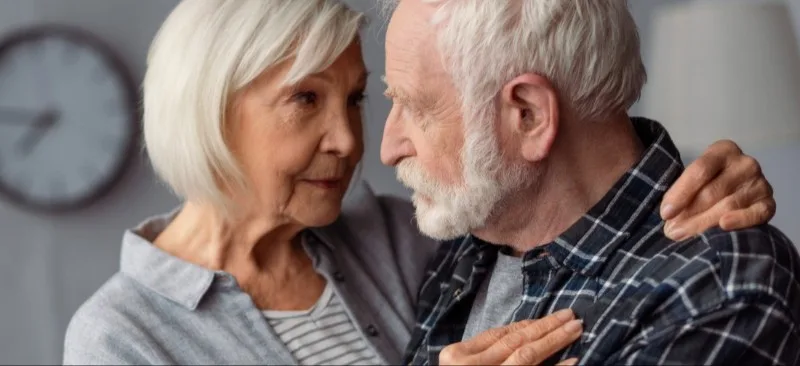 Elderly couple embracing and looking at each other