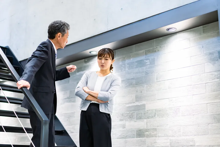 Man confronting woman on stairwell