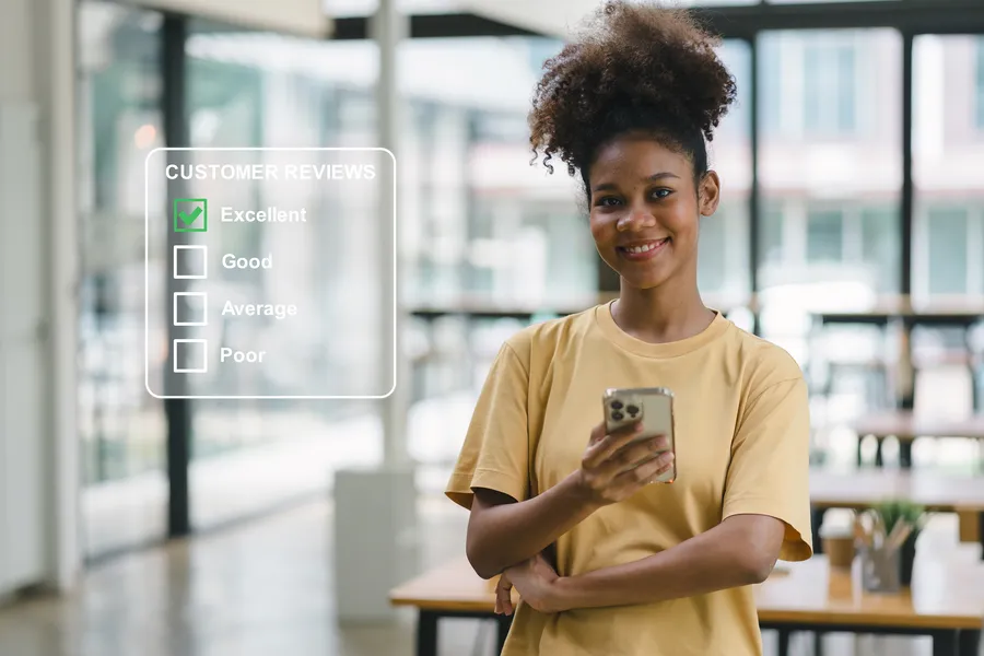 Young person standing in modern store holding smartphone