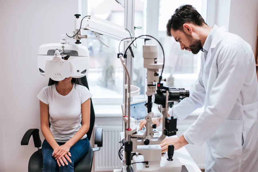 Patient undergoing eye exam with diagnostic equipment
