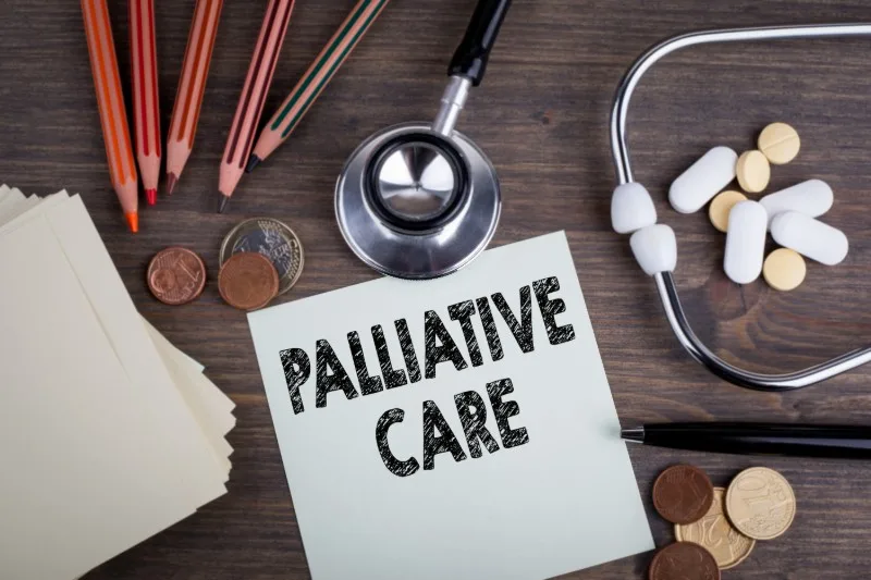 Stethoscope and pills with 'Palliative Care' note