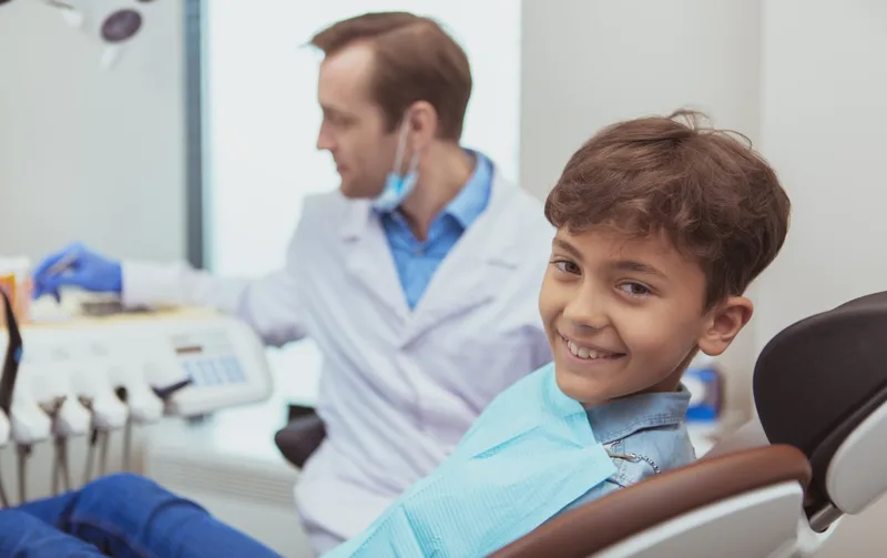 Smiling young boy in dental chair