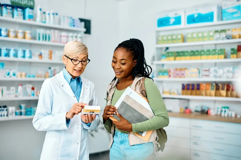 Pharmacist explaining medication to customer