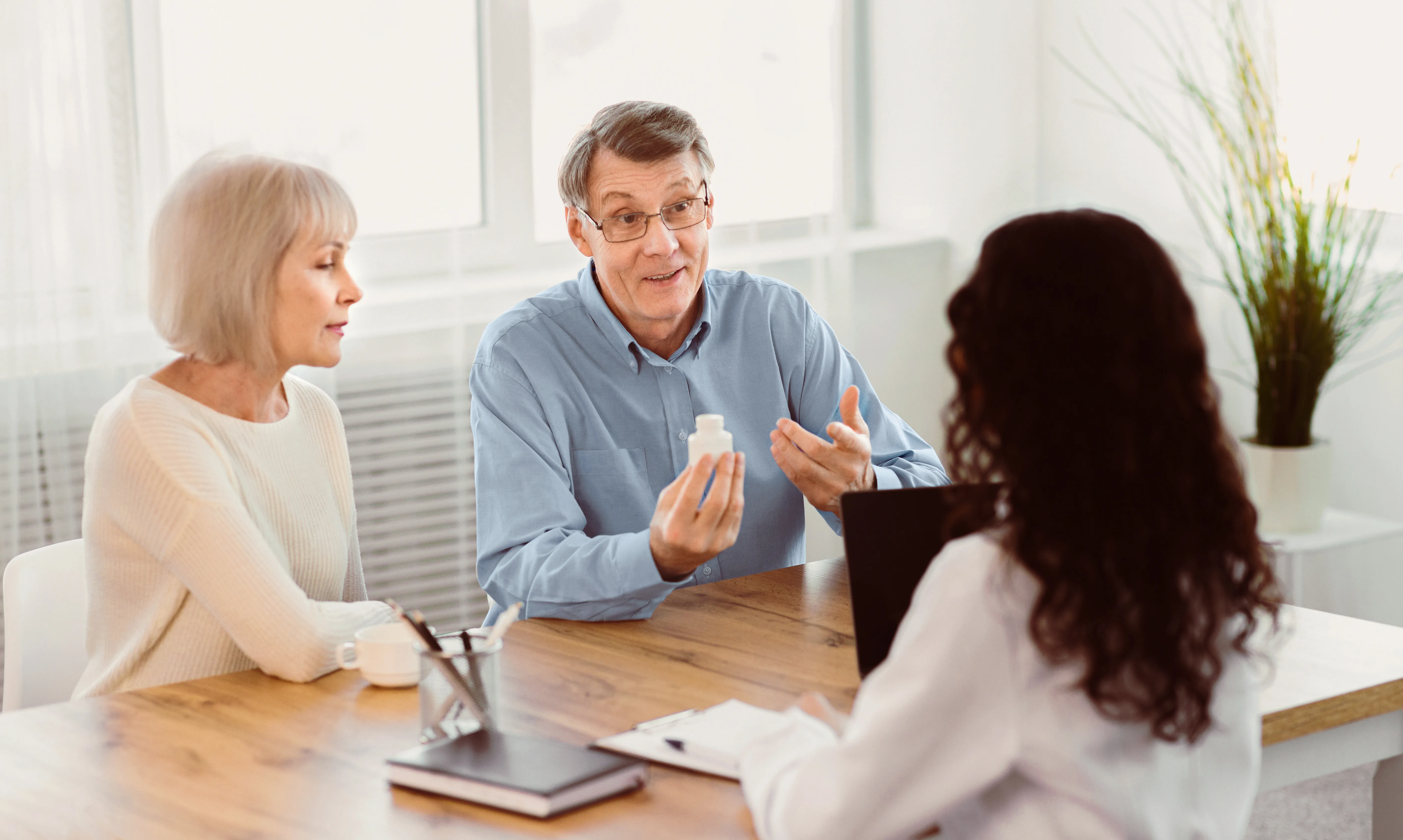 Older couple consulting with healthcare professional
