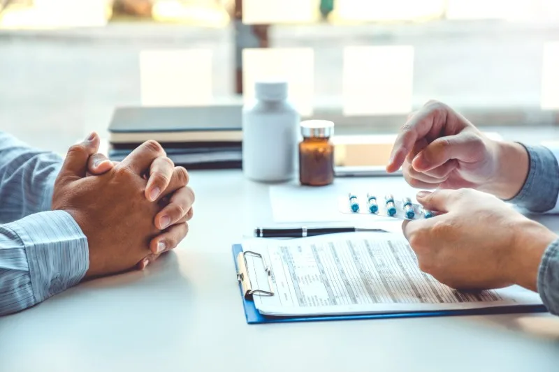 Pharmacist explaining options during a consultation
