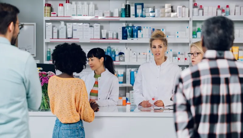 Pharmacy counter with staff and customers