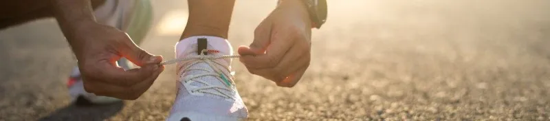 Person stretching outdoors at sunrise
