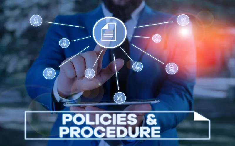 Person in suit touching digital policies icon