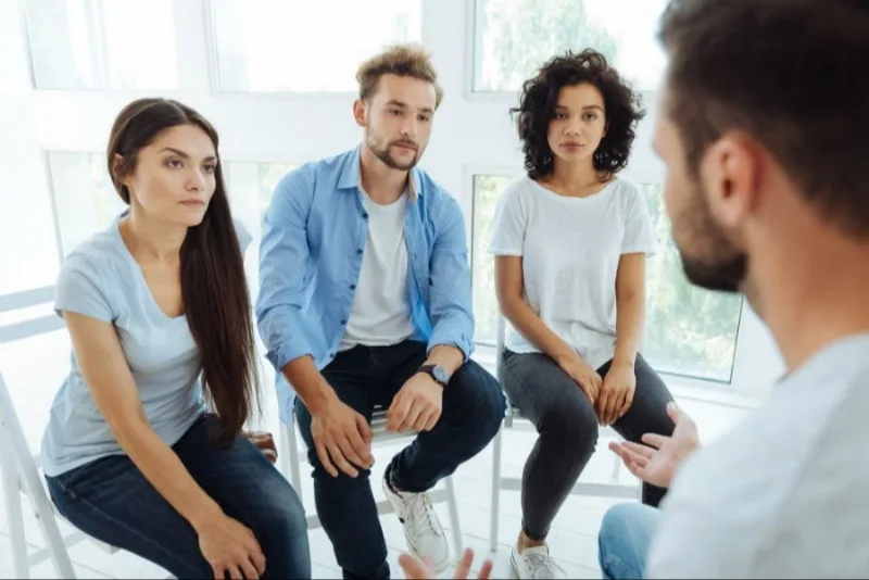Four adults seated in a small discussion circle