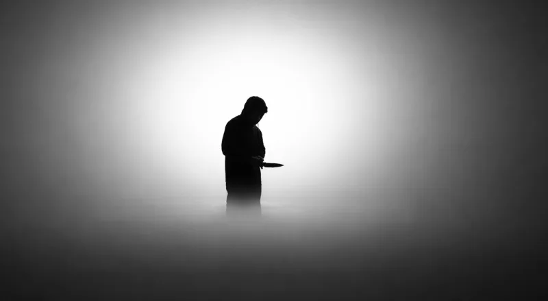 Silhouette of person standing in fog