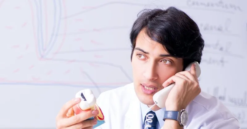 Person on phone holding pill bottle