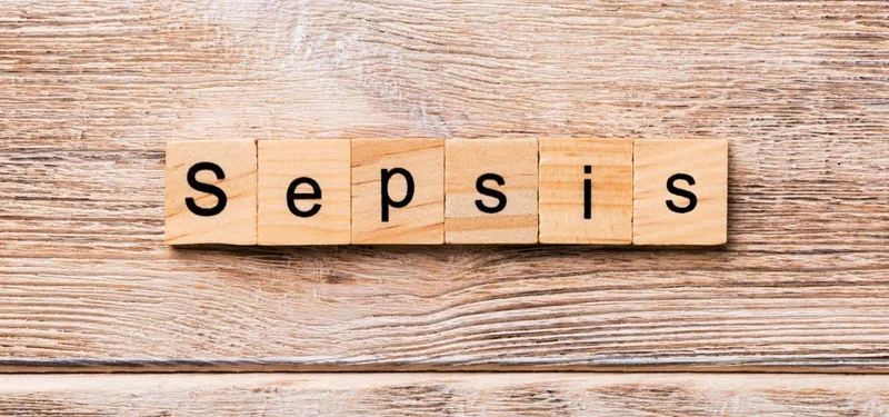 Wooden letter tiles spelling Sepsis on wood
