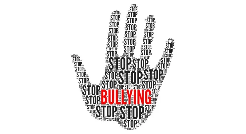 Hand silhouette made of repeated 'STOP' text with 'BULLYING'