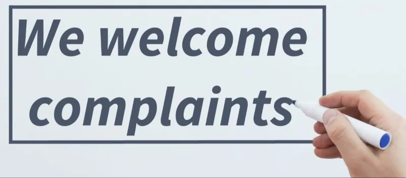 Sign reading We welcome complaints on whiteboard